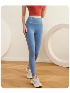 Detail view of high waist yoga leggings with light blue denim texture and slim fit design