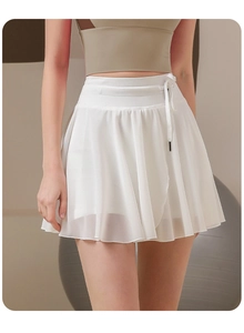 Detail of white pleated mesh tennis skirt featuring drawstring waist and inner shorts