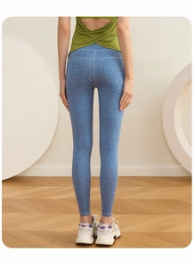Rear view of high waist yoga pants in denim blue with body contouring stitching details