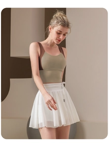 Detail of white pleated tennis skirt showing drawstring waist and breathable mesh fabric