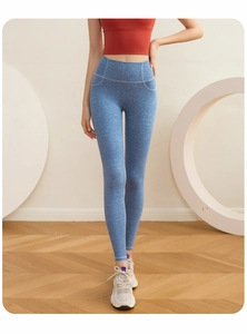 Close-up of high-waist light blue yoga pants with denim-style stitching and marl texture