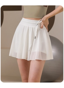 Detail of white mesh tennis skirt featuring drawstring waist and protective inner shorts