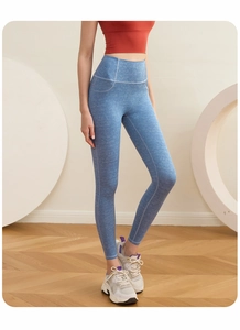 Detail of high-waist light blue yoga pants with denim texture print on a model