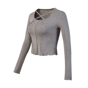 Slim fit dark grey long sleeve yoga top with crisscross neck and lettuce edge trim