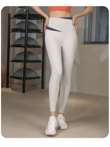 Gros plan d'un legging de yoga taille haute avec taille croisée contrastée en salle