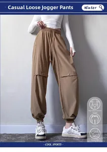 Detail view of khaki jogger pants showing high waist drawstring and cargo pocket buttons