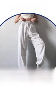 Detail of light beige high-waisted joggers featuring drawstring waist and cargo flap pocket