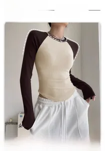 Detail view of contrast raglan sleeves and slim fit crewneck on a yoga long sleeve top