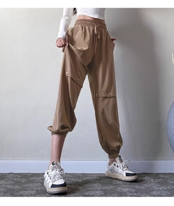 Close-up of khaki cargo jogger pants with elastic drawstring waist and button pockets