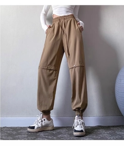 Detailed view of cargo joggers featuring elastic drawstring waist and buttoned pocket detail