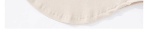 Detail view of the seamless curved hem and fine stitching on the beige yoga long sleeve