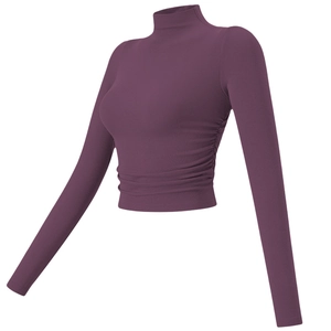 Detail of purple ribbed knit yoga top featuring a high neck and ruched side design