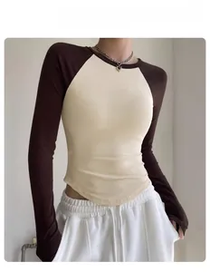 Detail of color-block raglan long sleeve yoga top with ribbed texture and slim fit design