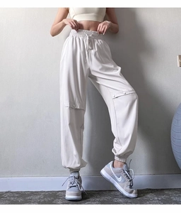 Detail of cream yoga joggers with adjustable drawstring waist and cargo side pockets