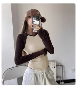 Close-up of slim-fit contrast raglan yoga top with brown sleeves and beige body