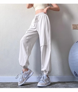 Detail of off-white high-waisted cargo joggers with drawstring waist and side flap pocket