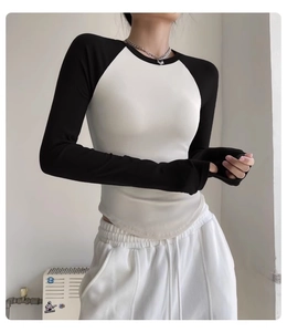Slim fit raglan sleeve yoga top with black and white color block and ribbed texture