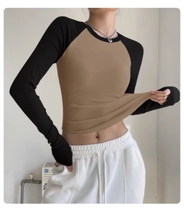 Close-up of stretchy two-tone raglan sleeve yoga top showing high elasticity fabric