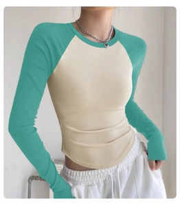 Detailed texture of slim fit ribbed yoga top with contrasting raglan long sleeves
