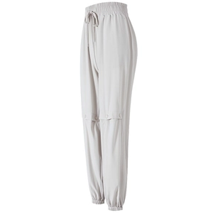 Loose high-waisted jogging pants in light grey with drawstring and knee button detail