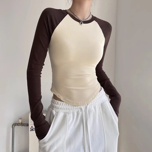 Slim fit contrast color yoga top with cream body, brown raglan sleeves and curved hem