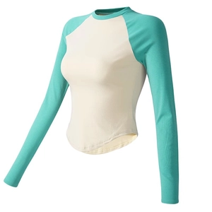 Slim fit long sleeve yoga top with mint green raglan sleeves and curved hemline