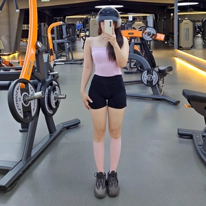 High-waist yoga shorts with side drawstrings and slim fit workout top in gym setting