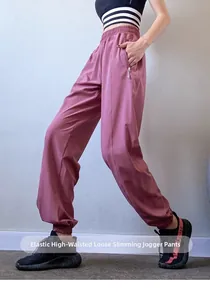 Detail view of pink high-waist joggers with elastic waistband and hidden zipper pockets