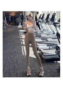 Detailopname van de kaki yoga-broek met hoge taille en sport-bh in de sportschool