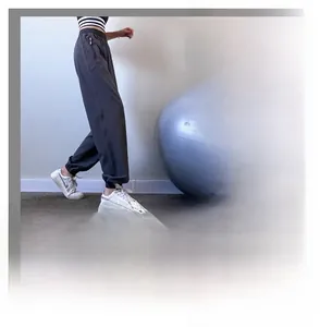 Detail of high waist dark grey sweatpants featuring secure side zipper pockets and cuff