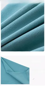 Detail of wide elastic waistband and ribbed texture on dark teal yoga shorts