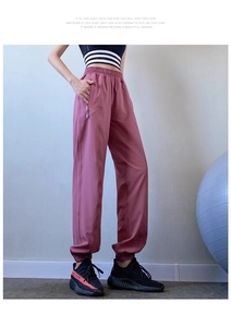 Detail of high waist dusty pink joggers with hidden zipper pockets and elastic cuffs