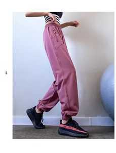 Detail shot of pink high waist cargo joggers featuring elastic cuffs and side zipper pockets