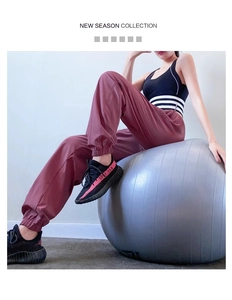 Close-up of high-waist quick-dry joggers paired with a sports bra on a fitness ball
