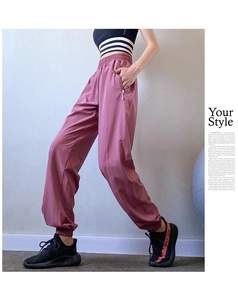 Detail view of high waist pink joggers with functional side zipper pockets and elastic cuffs