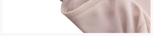 Macro detail of beige yoga shirt fabric showing premium stitching and soft knit texture