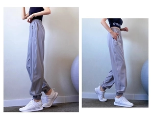 Detail view of high waisted light purple jogger pants with side zip pocket and elastic cuffs