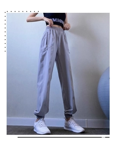 Detail of light purple high waist joggers featuring side zipper pockets and elastic waistband