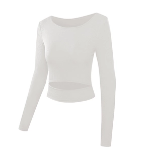 Close-up of white ribbed knit fabric and cutout waist design on long sleeve crop top