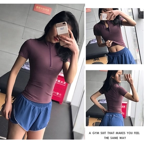 Detailed views of women's zip-up sports t-shirt and athletic shorts set in gym