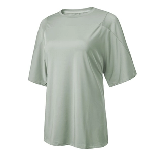 Close-up of lightweight light green mesh fabric and stitching on loose yoga t-shirt
