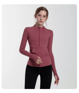 Detail of dusty rose half-zip sports top featuring thumbholes for athletic fit