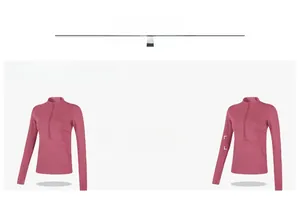 Detail of pink half-zip workout top featuring thumbholes and custom logo placement