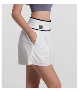 Detail of high-waist white sports shorts with BK patch and black contrast stitching