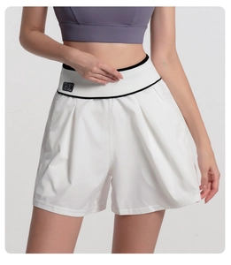 Detail of high-waisted gym shorts featuring a BK patch on the ribbed waistband