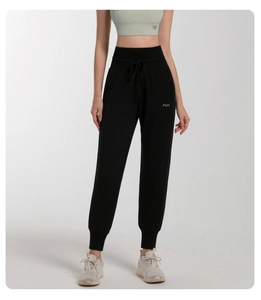 Detail of high waist drawstring and PUH logo on black women joggers