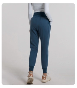 Detail view of high waist waistband and tapered cuffs on breathable yoga joggers