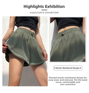 Detail view of olive green double-layered sports shorts with elastic drawstring waistband