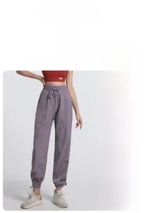 Detail of high-waisted jogging pants with elastic drawstring waist and cuffed hems