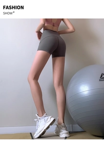 Detail view of high-waist charcoal grey athletic shorts with tummy control and seamless design